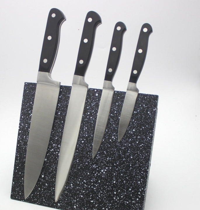 Tool storage rack MDF magnetic knife holder with four kitchen knives on speckled black board