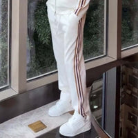 Alt Tag: Affordable Luxury Patchwork Striped Casual Sports Suit High-End Stand-Up Collar Jacket And Pants Two-Piece Set white striped pants